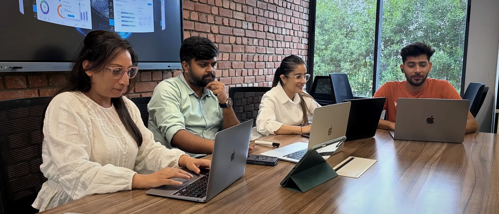 The team reviewing product dashboards at the studio table