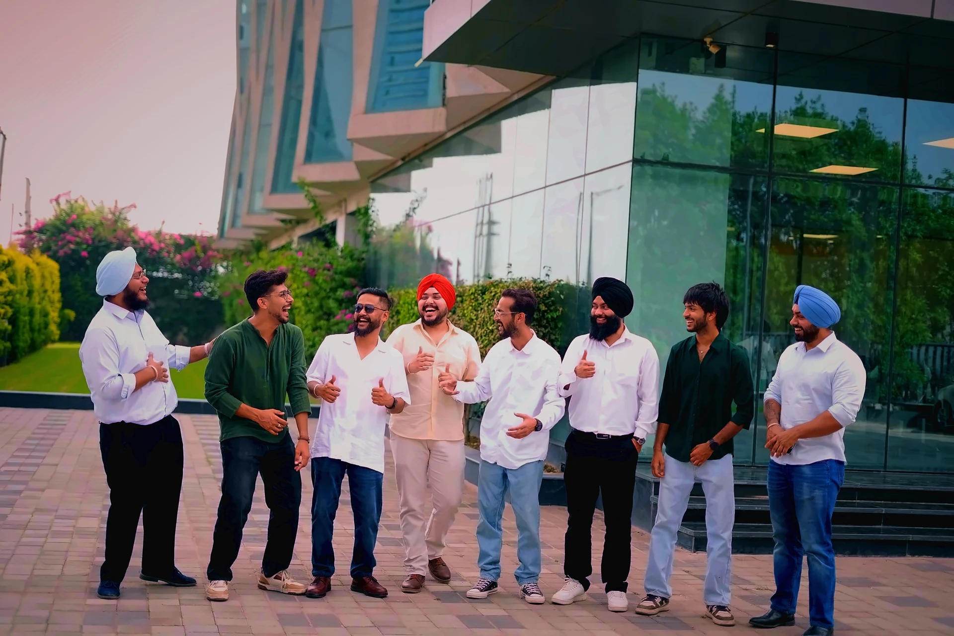 Outside the glass at Alpha IT City — the team, mid-laugh
